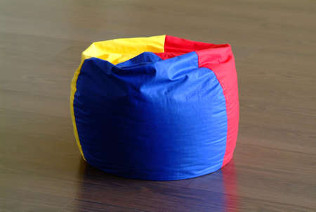 a seat in three colours on a floorの写真素材