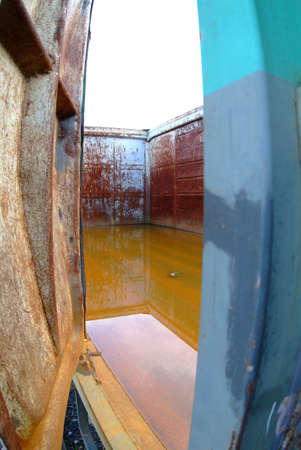 a rusty waggon inside with water filledの写真素材