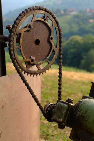 a rusty gearwheel with a small motorの写真素材