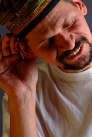 a young men is holding one hand to his ear