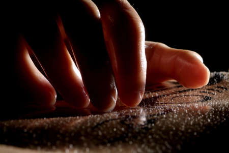 hand on a  body detail with black tattoo on itの写真素材