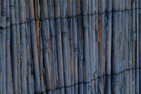 a old brown bamboo fence with wireの写真素材