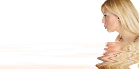 a young woman blow something from her handの写真素材