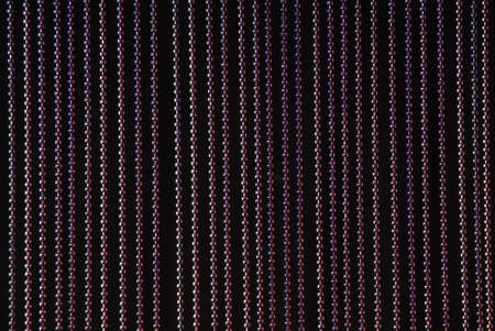 a red lit string curtain on black background