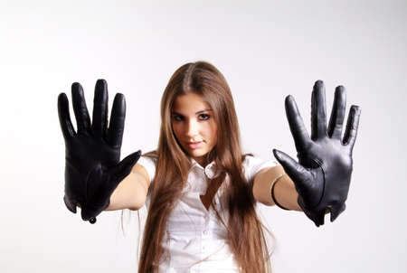 pretty woman with long hair and black leather gloveの写真素材