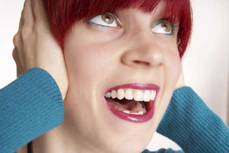 woman with red hair keeps ear closed