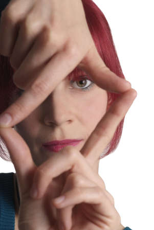 young woman holding fingers like frame in front of faceの写真素材