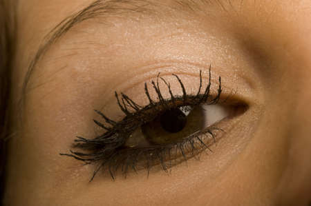 one female open brown eye with make-up