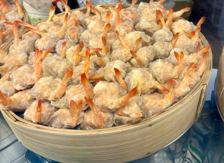 Fried shrimp in bamboo basket for sale at Thai street food market.の写真素材