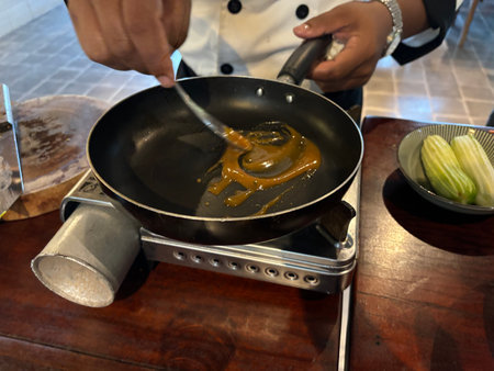 Chef cooking in a restaurant kitchen, Chef preparing food in a panの写真素材