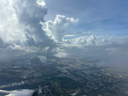 Aerial view of the city and clouds from the plane window.の写真素材