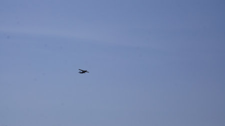 airplane flying in the blue sky, closeup of a photo
