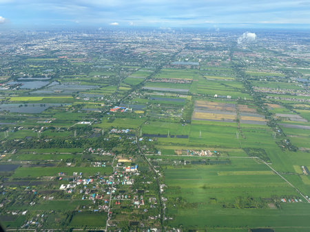 Aerial view of farmland and buildings in rural area of Thailand.