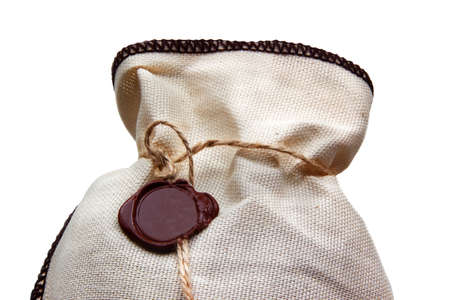 Linen bag with brown wax seal isolated on whiteの写真素材