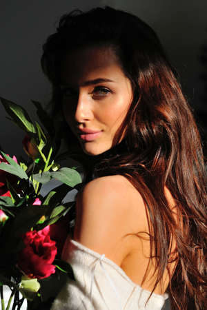 girl with flowers on a black backgroundの写真素材