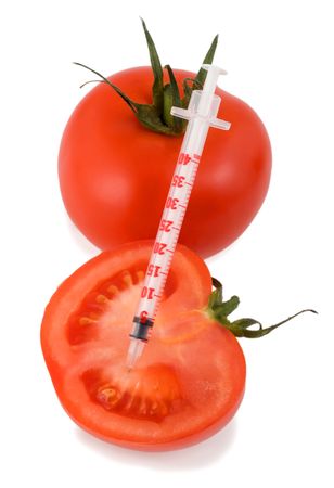 insulin syringe in tomatoes isolated on white backgroundの写真素材