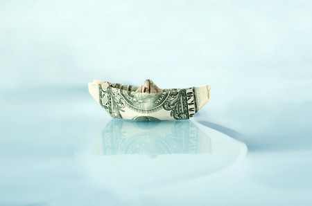 Ship made of money dollar in waterの写真素材