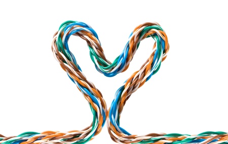 Multicolored computer cable form heart isolated on white backgroundの写真素材