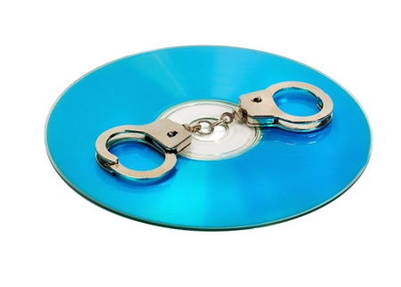 Pair of handcuffs on a CD computerの写真素材