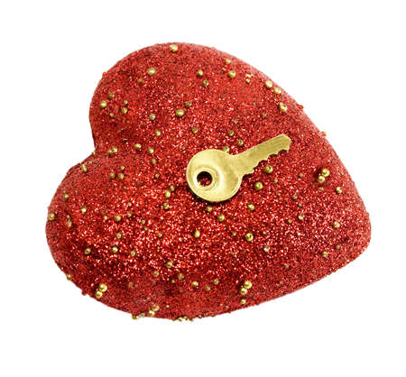 Golden key opens the heart isolated on white backgroundの写真素材