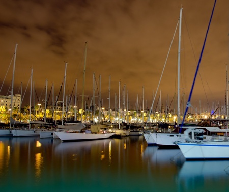 Night sailboats at Port Vell, Barcelona Spain の写真素材