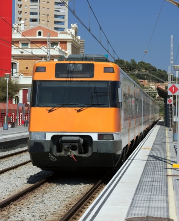 Modern orange train on station  Barcelona, Spain のeditorial素材