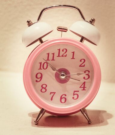 alarm clock in the foreground grunge abstract background 