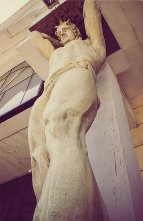 Old sculpture of atlant architectural background grungeの写真素材