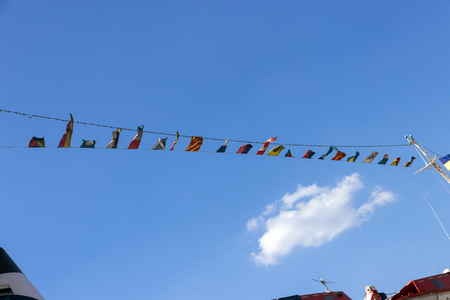 Nautical signal flags against blue sky on  Cruise ship