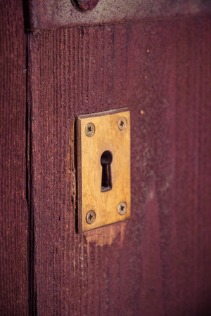 key hole in old wooden door. Vintage retro styleの写真素材