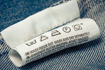 Label clothes symbols description, jeans blue background.