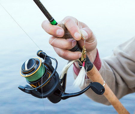 fisherman with a fishing reel spinner Spoon