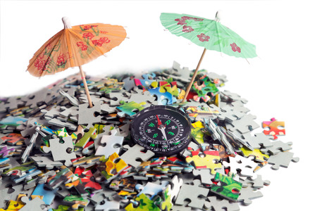 compass, umbrella in beach puzzle - concept journey islandの写真素材