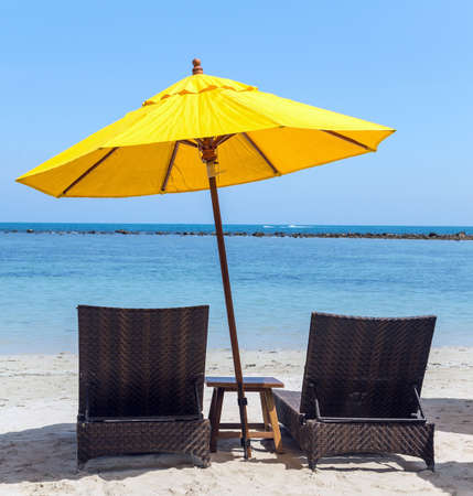 beach yellow umbrella on sand beach - vacation conceptの写真素材