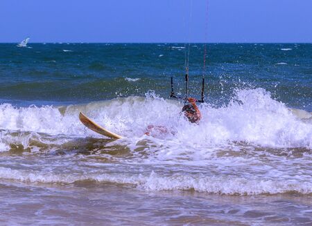 Man kite surfer in action over wavy sea surfaceの写真素材