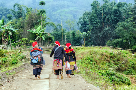 Red Dao woman cariies her little baby on her back, TA PHIN, LAO CAI, VIETNAMのeditorial素材