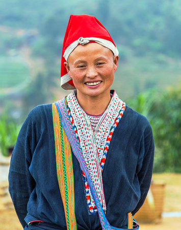 TA PHIN, LAO CAI, VIETNAM - NOV 21, 2014: Woman from Red Dao minority group wearing traditional headdress near Ban Ho village, Sapa District, Lao Cai, Vietnam.のeditorial素材