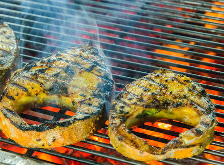 Grilled fish on flaming iseafood restaurantの写真素材