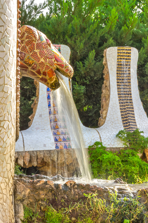 Mosaic snake fountain at the Parc Guell designed by Antoni Gaudi located on Carmel Hill, Barcelona, Spain.のeditorial素材