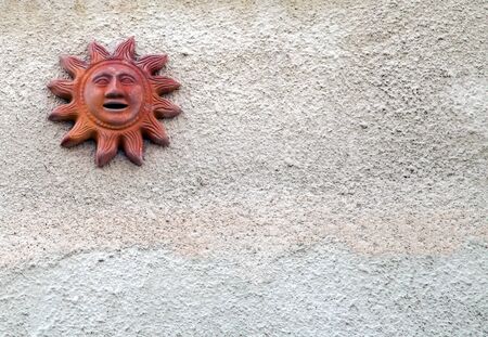 sun ceramic on beige cement background wallの写真素材