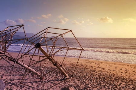 umbrella in afternoon sun reflecting empty beachの写真素材