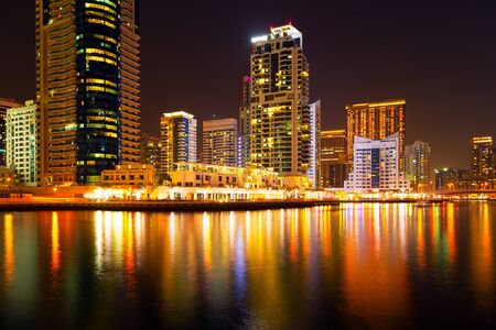 Dubai marina illuminated in night, United Arab Emirates - panorama of skyscrapersのeditorial素材