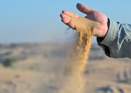 sand in hands of desert conceptの写真素材