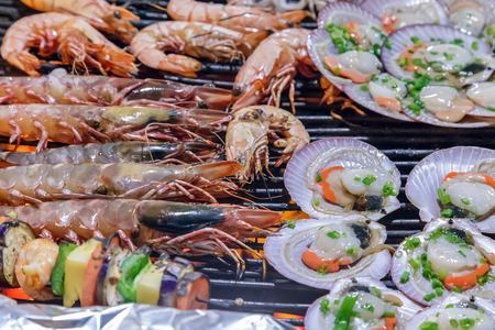 Barbecue fire grill, shellfish mollusks seashells, oysters delicacies. Seafood cuisine backgroundの写真素材