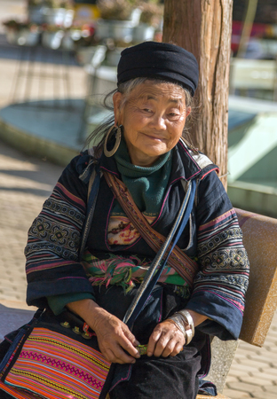 LAO CAI, VIETNAM - NOV 21, 2014: Old Woman from Hmong minority group wearing traditional headdress near Sapa, Lao Cai, Vietnam.のeditorial素材