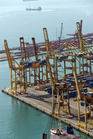 BARCELONA, SPAIN - AUGUST 27, 2012: Terminal Port Nou, ?ontainer ship in import export and business logistic, By crane, Trade Port, Ship, cargo to harbor Barcelona. Catalonia, Spain.のeditorial素材