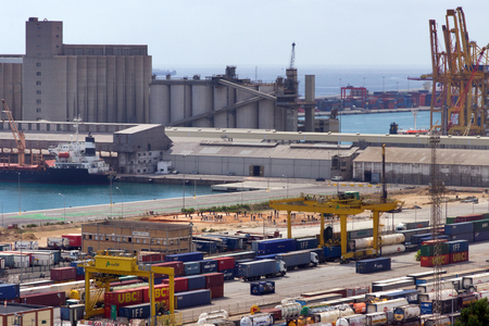 BARCELONA, SPAIN - AUGUST 27, 2012: Terminal Port Nou, ?ontainer ship in import export and business logistic, By crane, Trade Port, Ship, cargo to harbor Barcelona. Catalonia, Spain.のeditorial素材