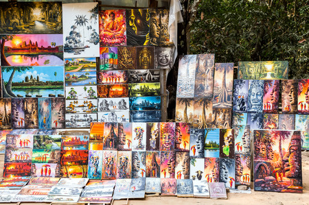 SIEM REAP, CAMBODIA - 01 MARCH, 2015 - Tourists market for paintings drawing pictures of Angkor Wat, Cambodia, Khmer temple complex, Asia. Ancient Khmer architecture in jungle.のeditorial素材