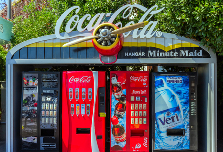 BARCELONA, SPAIN - AUGUST 26, 2012: Coca- Cola sign on the top of the red vintage machine cabinet is a carbonated soft drink produced by The Coca-Cola Company and wood aircraft propeller systems, Parc d'Atraccions del Tibidabo, Barcelona.のeditorial素材