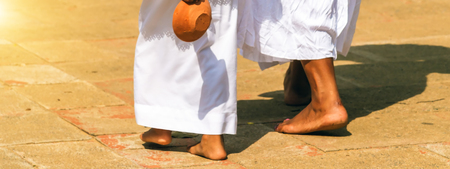 Feet young woman walking female legs on the road at sunrise or sunset.の写真素材